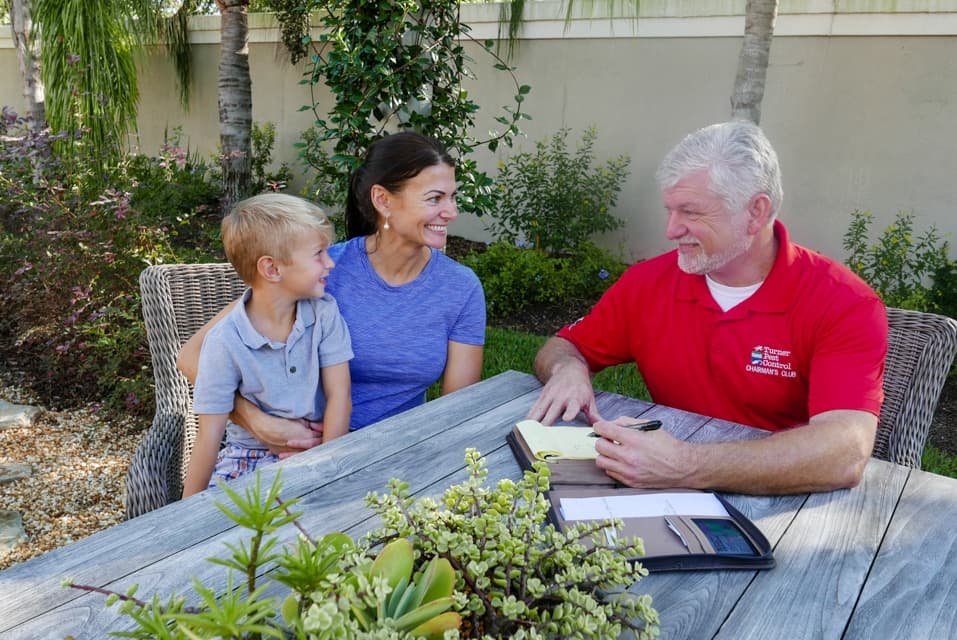 Turner Pest Control technician assisting a homeowner